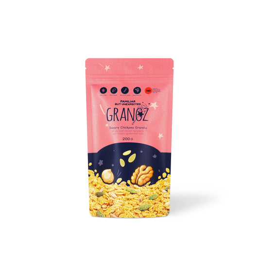 A stand-up pouch of Fanua by Blended Granz Scary Chicken Grains mix, featuring a pink top half with white stars and a dark navy bottom half showing illustrated grains and nuts, on a white background.